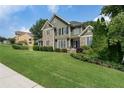 Charming two-story home with a stone and siding exterior and a beautifully manicured lawn at 203 Crescent Moon Way Way, Canton, GA 30114
