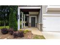 Inviting front entrance with covered porch and manicured landscaping at 301 Hayden Cir, Woodstock, GA 30189