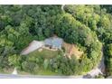Secluded home surrounded by mature trees offering privacy and a peaceful setting at 3990 Wesley Chapel Rd, Marietta, GA 30062