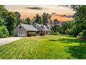 Beautiful single Gathering home with mature trees, long driveway, and attached garage at 3990 Wesley Chapel Rd, Marietta, GA 30062