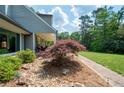 Serene landscape design, complete with mulched beds, shrubbery and a stone walkway at 3990 Wesley Chapel Rd, Marietta, GA 30062