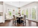 Dining room with chandelier, modern furnishings, and beautiful outdoor view at 4776 Highside Way, Smyrna, GA 30082
