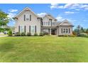 Beautiful two-story home featuring manicured lawn, complemented by modern gray siding and well-placed shrubbery at 7820 Longview Dr, Cumming, GA 30041