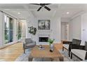 Inviting living room with fireplace, hardwood floors, coffered ceilings, and a view of the staircase at 2196 Niles Ne Pl, Atlanta, GA 30324