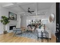 Bright living room featuring hardwood floors, fireplace, and a seamless transition to the dining area and kitchen at 2196 Niles Ne Pl, Atlanta, GA 30324