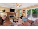 Inviting living room with a brick fireplace, neutral walls, and access to the outdoor deck at 2621 Garland Way, Duluth, GA 30096