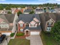 Charming two-story brick home with a well-manicured lawn and attached two-car garage at 3460 Drayton Manor Run, Lawrenceville, GA 30046
