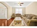 Inviting living room featuring hardwood floors, neutral walls, and comfortable seating at 3460 Drayton Manor Run, Lawrenceville, GA 30046