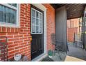 Outdoor entry featuring a black door, brick facade, and outdoor seating at 4282 Roswell Ne Rd # K3, Atlanta, GA 30342