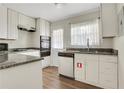 Bright kitchen with white cabinetry, granite countertops, stainless steel appliances, and modern flooring at 4282 Roswell Ne Rd # K3, Atlanta, GA 30342