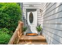 Inviting front entrance with a decorative glass door, flanked by potted plants, and a charming wooden porch at 884 Edgewater Cir, Marietta, GA 30062