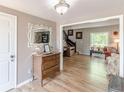 Inviting entryway featuring a decorative mirror, hardwood floors, a staircase, and views into the living space at 2229 S Van Wert S Rd, Villa Rica, GA 30180