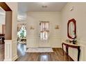 Elegant entryway with hardwood floors, detailed trim, and a decorative table with a mirror at 2837 Peachstone Ct, Lawrenceville, GA 30043