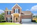 Beautiful brick home with covered entry, two-car garage, and manicured front lawn at 2928 Riverset Ct, Decatur, GA 30034