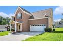 Brick-exterior two-story home with attached garage and well-maintained lawn at 2928 Riverset Ct, Decatur, GA 30034
