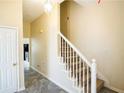 Inviting hallway featuring stylish tile flooring and a staircase with white railings at 2928 Riverset Ct, Decatur, GA 30034