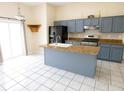 Modern kitchen with an island, granite countertops, stainless steel appliances, and ample cabinet space at 2928 Riverset Ct, Decatur, GA 30034