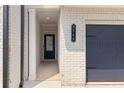 Close-up of the front entrance showcasing the house number, white brick, and a black front door at 3546 Sorrel Ln, Duluth, GA 30096