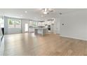 Open-concept living space with hardwood floors, a fireplace, and abundant natural light at 3546 Sorrel Ln, Duluth, GA 30096