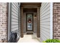 Inviting entrance with a decorative wreath on the door and well-maintained columns at 7628 Summer Berry Ln, Lithonia, GA 30038