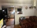 Cozy living room featuring hardwood floors, a decorative couch, and an open view to the kitchen at 10199 Starr Sw St, Covington, GA 30014