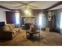 Spacious living room with a fireplace, ceiling fan, and ample space for furniture at 10199 Starr Sw St, Covington, GA 30014