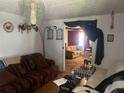 Inviting living room with comfortable seating and a glimpse into an adjacent room at 10199 Starr Sw St, Covington, GA 30014