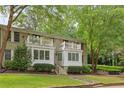 Inviting brick building with charming balconies, pristine white trim, and lush landscaping offering a blend of comfort and style at 1879 Johnson Ne Rd # 10, Atlanta, GA 30306