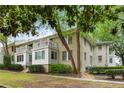 Serene view of a well-maintained brick building, accented with white trim, balconies, and mature trees against a soft sky at 1879 Johnson Ne Rd # 10, Atlanta, GA 30306