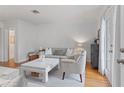 Bright living room with hardwood floors, neutral furniture, a white coffee table, and French doors leading to outdoor space at 1879 Johnson Ne Rd # 10, Atlanta, GA 30306