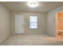 Bright, carpeted bedroom with natural light and an attached bathroom at 2104 Meadow Peak Rd, Duluth, GA 30097