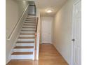 Inviting entryway with hardwood floors, a staircase, and neutral wall paint at 2104 Meadow Peak Rd, Duluth, GA 30097