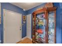 Interior hallway with storage cabinet against vibrant blue walls in apartment unit at 1705 Monroe Ne Dr # D05, Atlanta, GA 30324