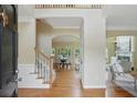 Inviting foyer with hardwood floors, staircase, and arched entryway to the dining room at 2802 Arabian Ne Trl, Marietta, GA 30062