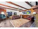 Spacious living room with exposed wood beams, wood paneling and a decorative area rug at 2905 Jim Owens Nw Rd, Kennesaw, GA 30152