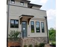 Inviting townhome entrance with brick accents, modern door, and well-maintained landscaping at 297 White St # 1, Marietta, GA 30060