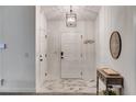 Inviting foyer with white walls, modern light fixture, and elegant tile flooring at 245 Raleigh Way, Villa Rica, GA 30180