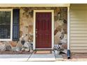 Close-up of front door with stone veneer, decorative black shutters, and a welcoming entryway at 2753 Fireside Se Ct, Marietta, GA 30067