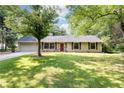 Inviting single-story home with a stone facade, lush lawn, and mature trees surrounding the property at 2753 Fireside Se Ct, Marietta, GA 30067