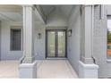 Inviting front entryway with double doors and stylish exterior lighting fixtures at 37 Deer Canyon Dr, Auburn, GA 30011
