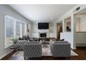 Sunlit living room featuring stylish seating, fireplace, and an open layout to the kitchen at 13 Ivy Ne Sq, Atlanta, GA 30342
