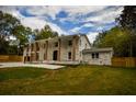 This two-story brick home features stately columns and fresh landscaping for curb appeal at 4395 Woodland Brook Se Dr, Atlanta, GA 30339