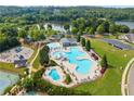 Aerial view of a community pool with a lake and greenery in the background on a beautiful sunny day at 510 Winder Trl, Canton, GA 30114