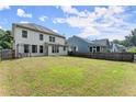 Spacious, grassy backyard enclosed by wooden fences, with a view of the home's back exterior at 510 Winder Trl, Canton, GA 30114