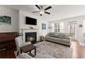 Bright living room with a cozy fireplace, piano, and comfortable seating area at 61 N Auburn Landing Pl, Auburn, GA 30011