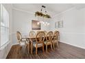 Formal dining room with a decorative light fixture and seating for eight at 701 Woodward Ct, Canton, GA 30114
