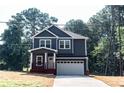Inviting two-story home boasting a well-maintained lawn, covered porch, and attached two-car garage at 102 Neal Ave, Stockbridge, GA 30281