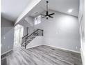 A spacious living room with high ceilings, modern flooring, and a staircase with dark metal railing at 102 Neal Ave, Stockbridge, GA 30281