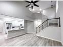 Open-concept living area features high ceilings, stairs, and a modern kitchen with stainless steel appliances at 102 Neal Ave, Stockbridge, GA 30281