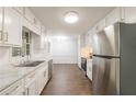 Modern kitchen with stainless steel appliances, ample counter space, and white cabinets at 1671 Drayton Woods Dr, Tucker, GA 30084